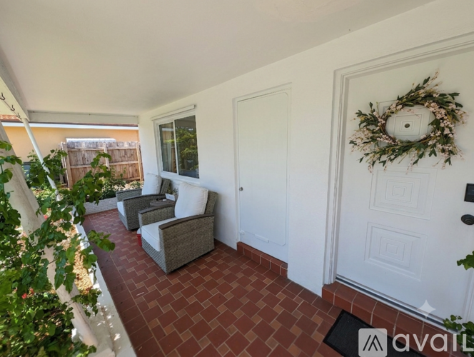 A room with a white door and a wreath on it.