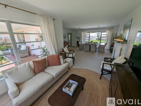 A living room with a white couch and a coffee table.