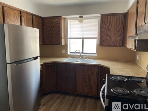 A kitchen with a stove and a refrigerator.