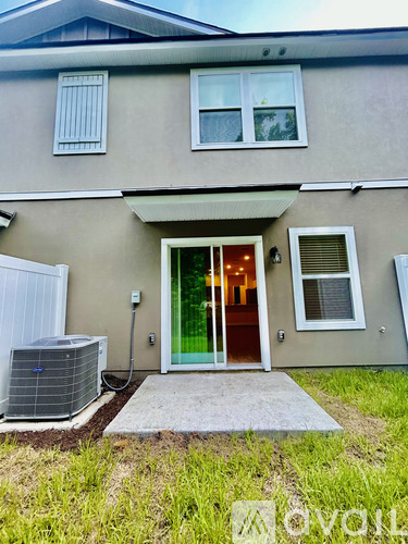 A house with a green door and a white fence.