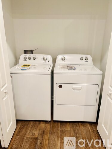A small laundry room with a washer and dryer.