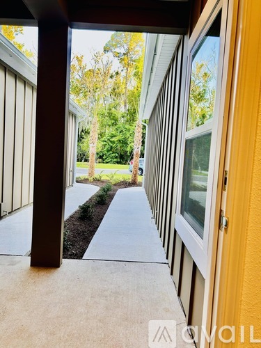 A view from inside a building looking out through a doorway to a garden.