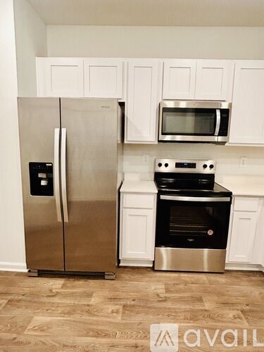 A kitchen with a stainless steel refrigerator and an oven.