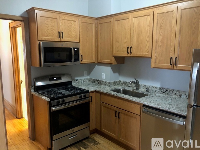A kitchen with wooden cabinets and stainless steel appliances.