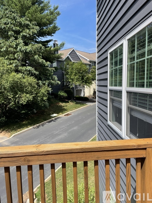 A house with a grey siding and a wooden deck.