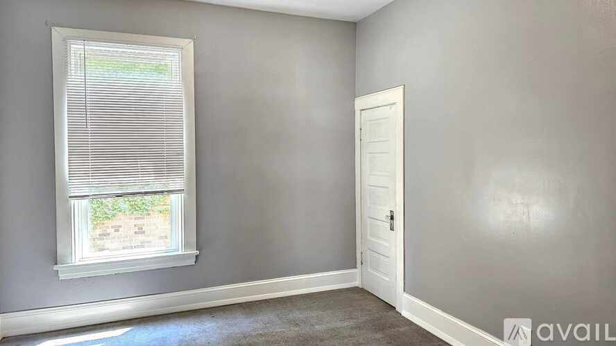 A room with a window and a door.