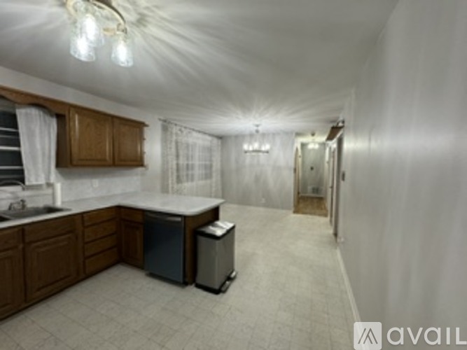 A kitchen with wooden cabinets and a dishwasher.