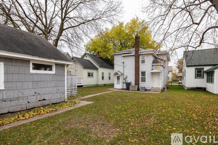 A row of houses with a grassy area in the foreground.