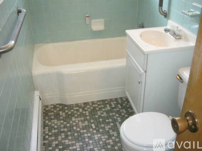 A bathroom with a white toilet, sink, and bathtub.