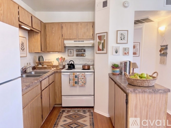 A kitchen with wooden cabinets and a white oven.