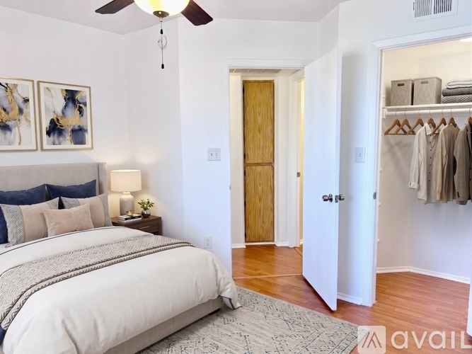A bedroom with a large bed and a ceiling fan.