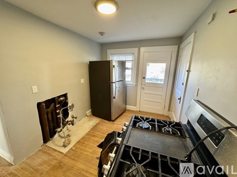 A kitchen with a black stove top oven and a black refrigerator.