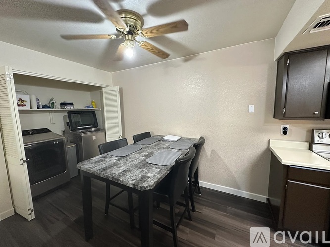 A kitchen with a table and chairs in the middle of the room.