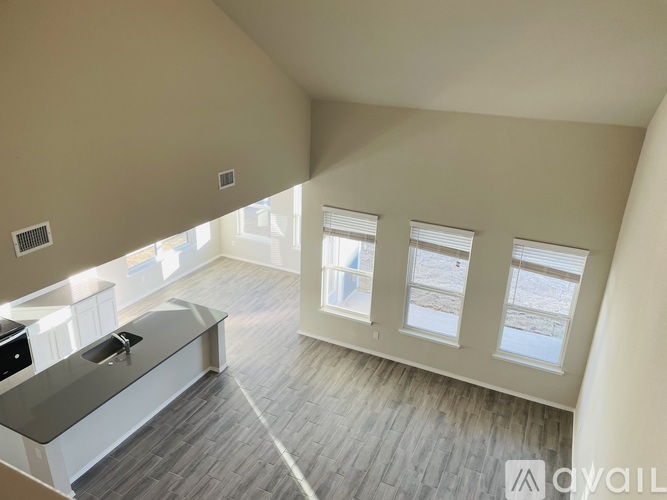 A spacious room with a large window and a counter.