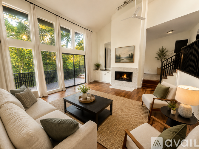 A living room with a fireplace and a painting on the wall.