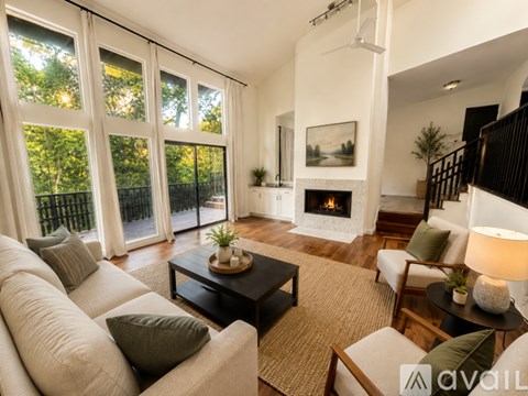 A living room with a fireplace and a painting on the wall.