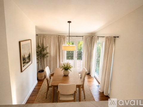 A dining room with a table set for four.