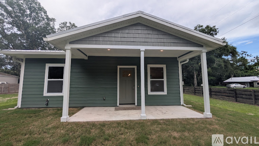 A small house with a porch is available for purchase.
