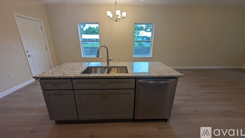 A kitchen with a granite countertop and a sink.