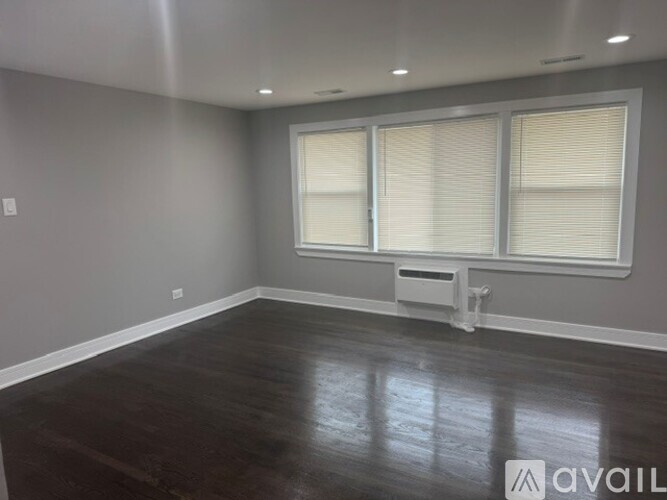 A room with wooden floors and grey walls.