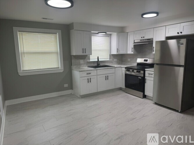 A kitchen with white cabinets and stainless steel appliances.