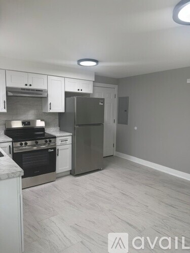 A kitchen with a refrigerator, stove, and oven.