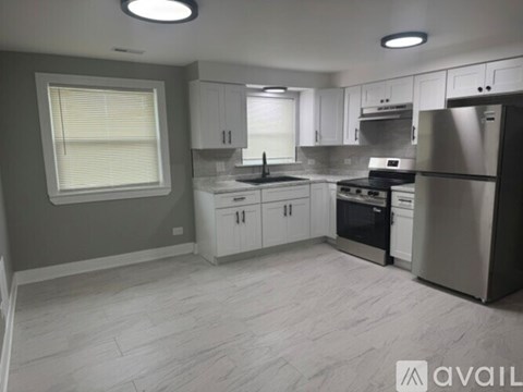 A kitchen with white cabinets and stainless steel appliances.