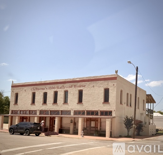 A white building with a sign that says "Cleburn's 1896 Railroad House".