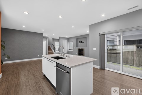 A modern kitchen with a dishwasher and a refrigerator.