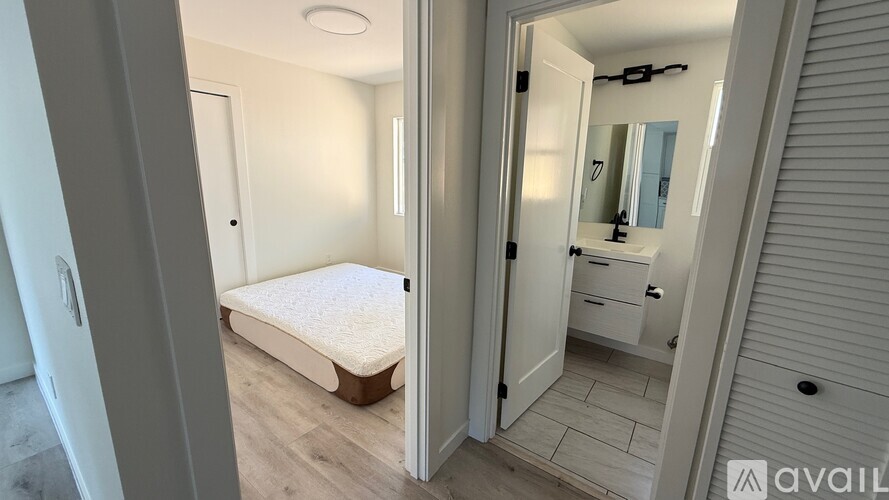 A bedroom with a bed, dresser, and mirror.