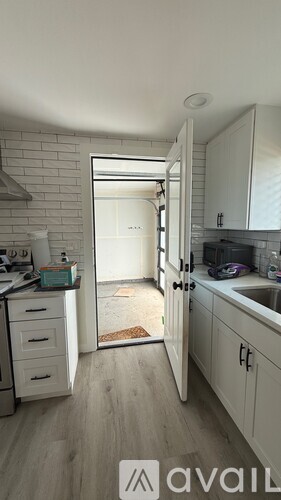 A kitchen with a white cabinet and a white fridge.