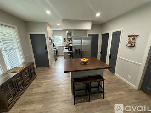 A kitchen with a table and chairs in the middle of the room.