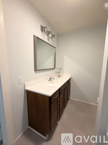 A bathroom with a sink and a mirror.
