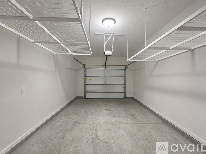A spacious, empty room with a concrete floor and white walls.