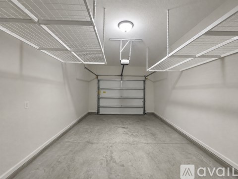 A spacious, empty room with a concrete floor and white walls.
