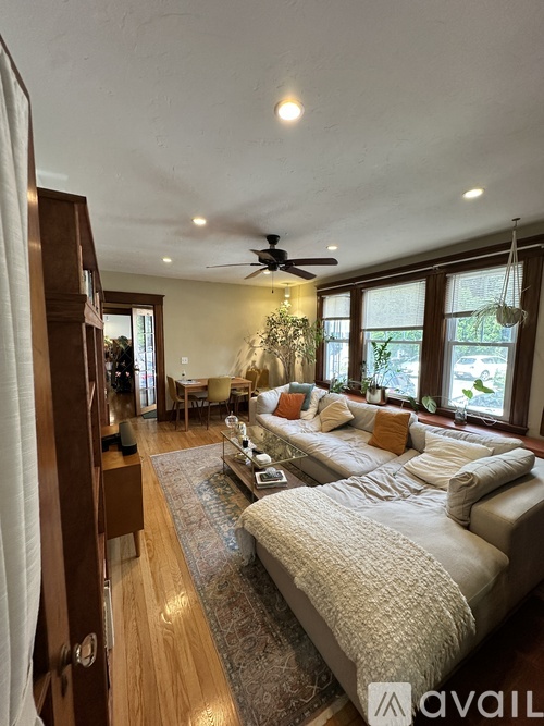 A bedroom with a large bed and a ceiling fan.