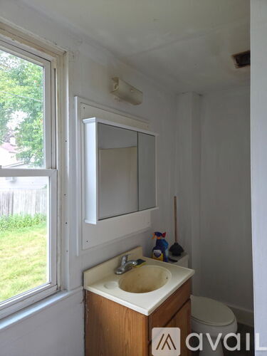 A bathroom with a sink, mirror, and toilet.