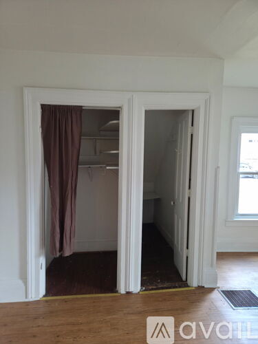 A room with a brown curtain and a white door.