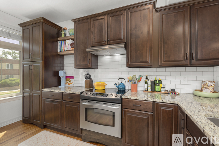A kitchen with wooden cabinets and a granite countertop.