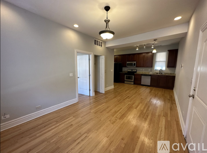 A room with wooden flooring and a ceiling light.