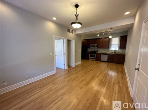 A room with wooden flooring and a ceiling light.