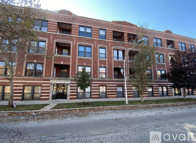 A large red brick building with many windows and doors.