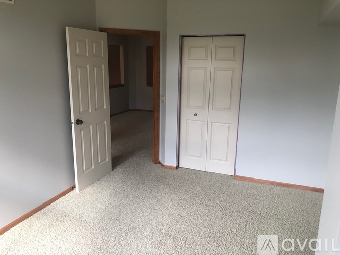 A room with two doors, one open and one closed.