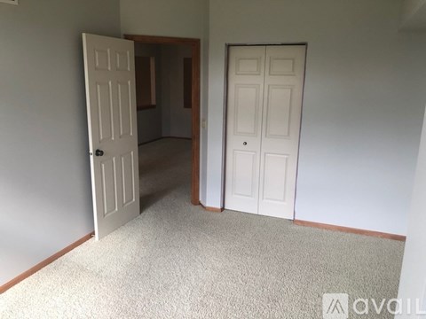 A room with two doors, one open and one closed.
