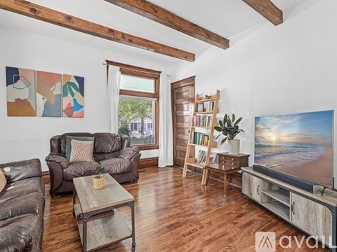 A living room with brown leather couches and a wooden coffee table.