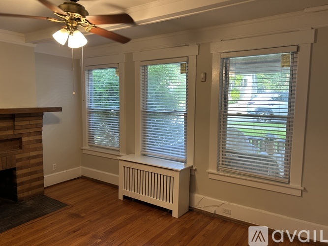 A room with a wooden floor and a large wooden door frame.