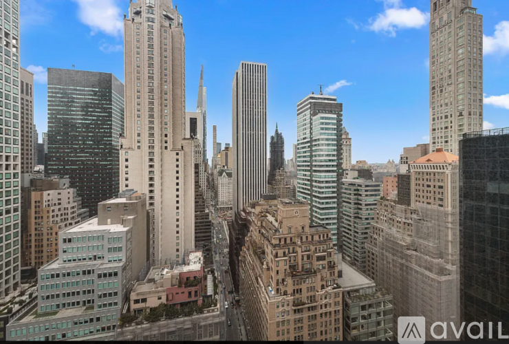 A cityscape with tall buildings and a clear sky.