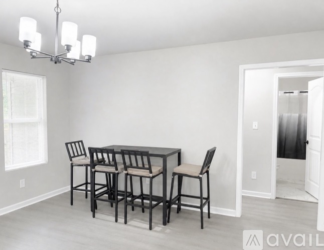 A dining room with a table and chairs.