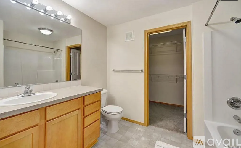 A bathroom with a toilet, sink, and bathtub.