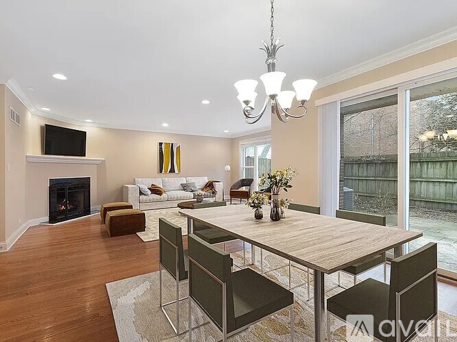 A modern dining room with a wooden table and chairs.